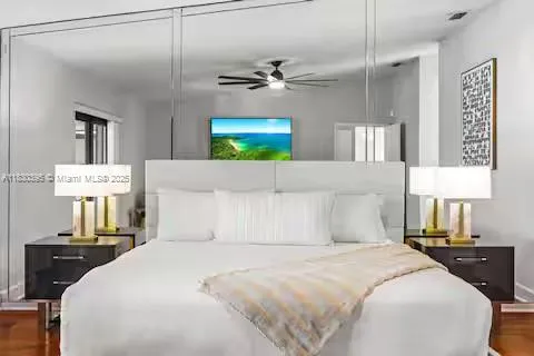 Mirror-backed headboard creates bedroom drama and space!