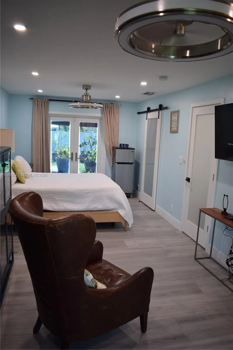 Spacious primary bedroom with flat ceiling, recessed lighting, double modern ceiling fans; and added bonus space perfect for reading, working from home, or relaxing