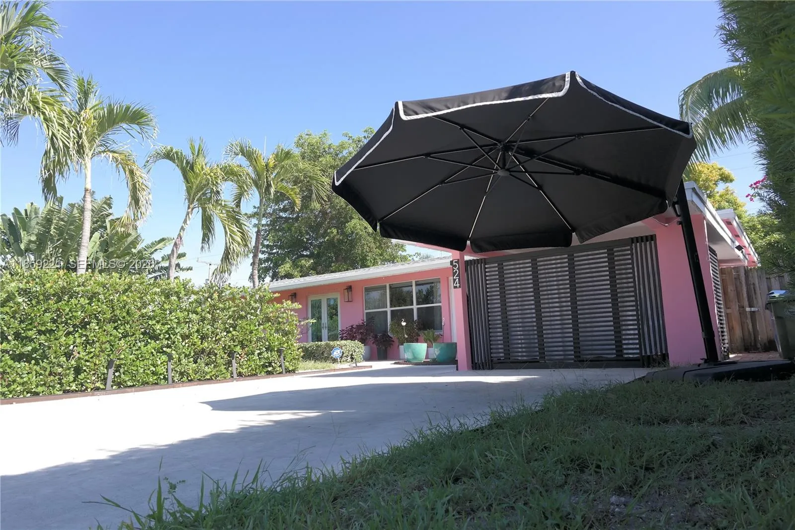Expansive front entrance featuring a wide driveway that accommodates four cars with ease.