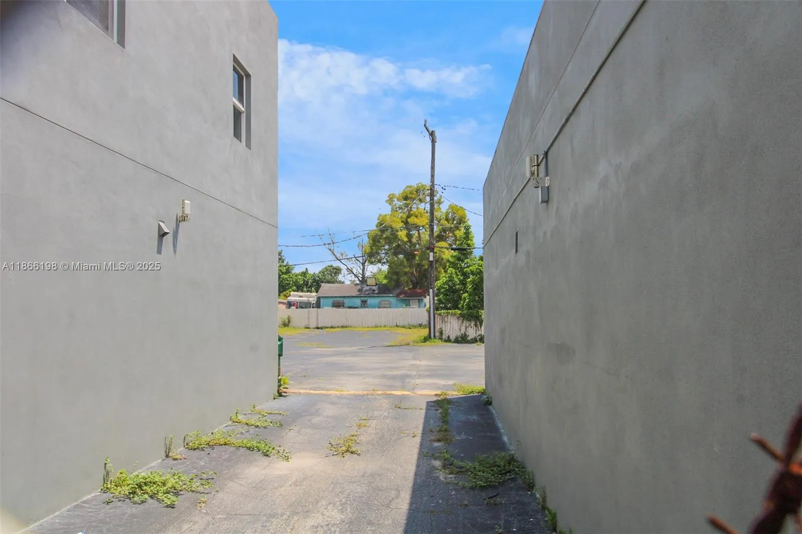 Drive between the two adjacent stand along buildings to access the large guest parking area.