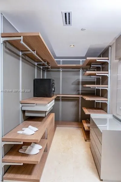 Primary Closet with leather panels and inside drawers.
