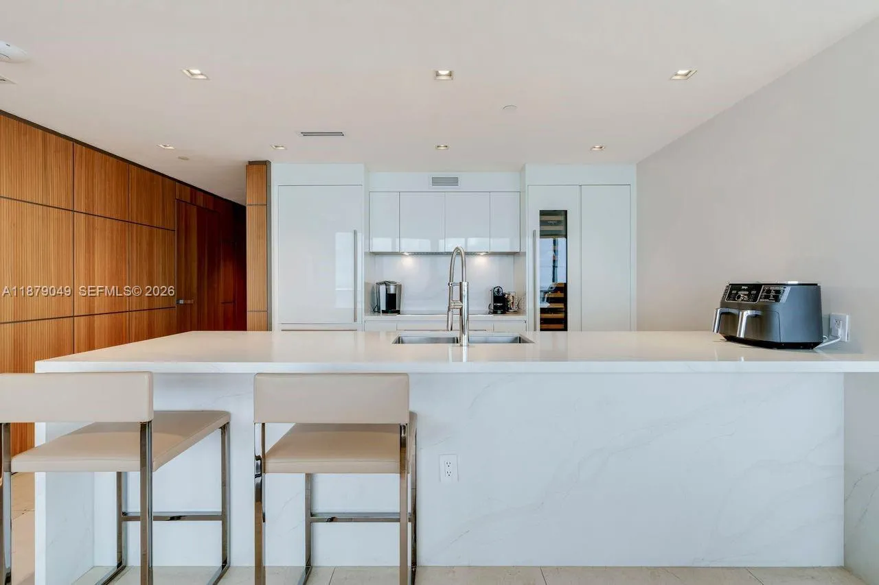 Premium Wolf appliances including a vertical wine cellar unit