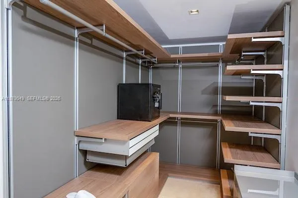 Primary Closet with leather panels and inside drawers.