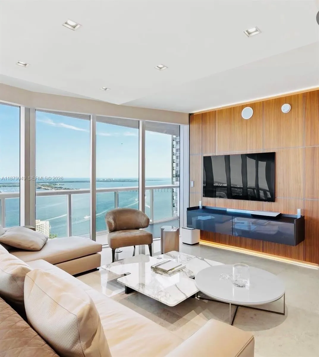 Open layout with lots of natural light, light fixtures and motorized  blackout Roller Shades on all glass windows and doors.