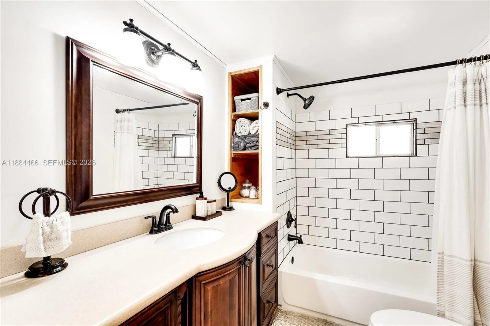 Refreshed primary bathroom with new shower tiling and new shower faucet