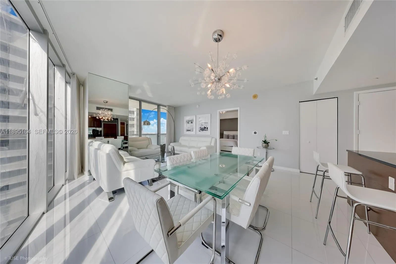 Dining and living room with view of the kitchen bar