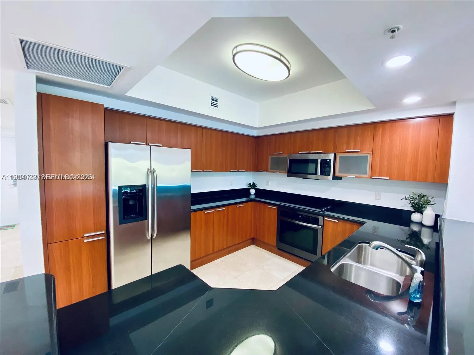 Open kitchen with stainless steel appliances and extra cabinets space