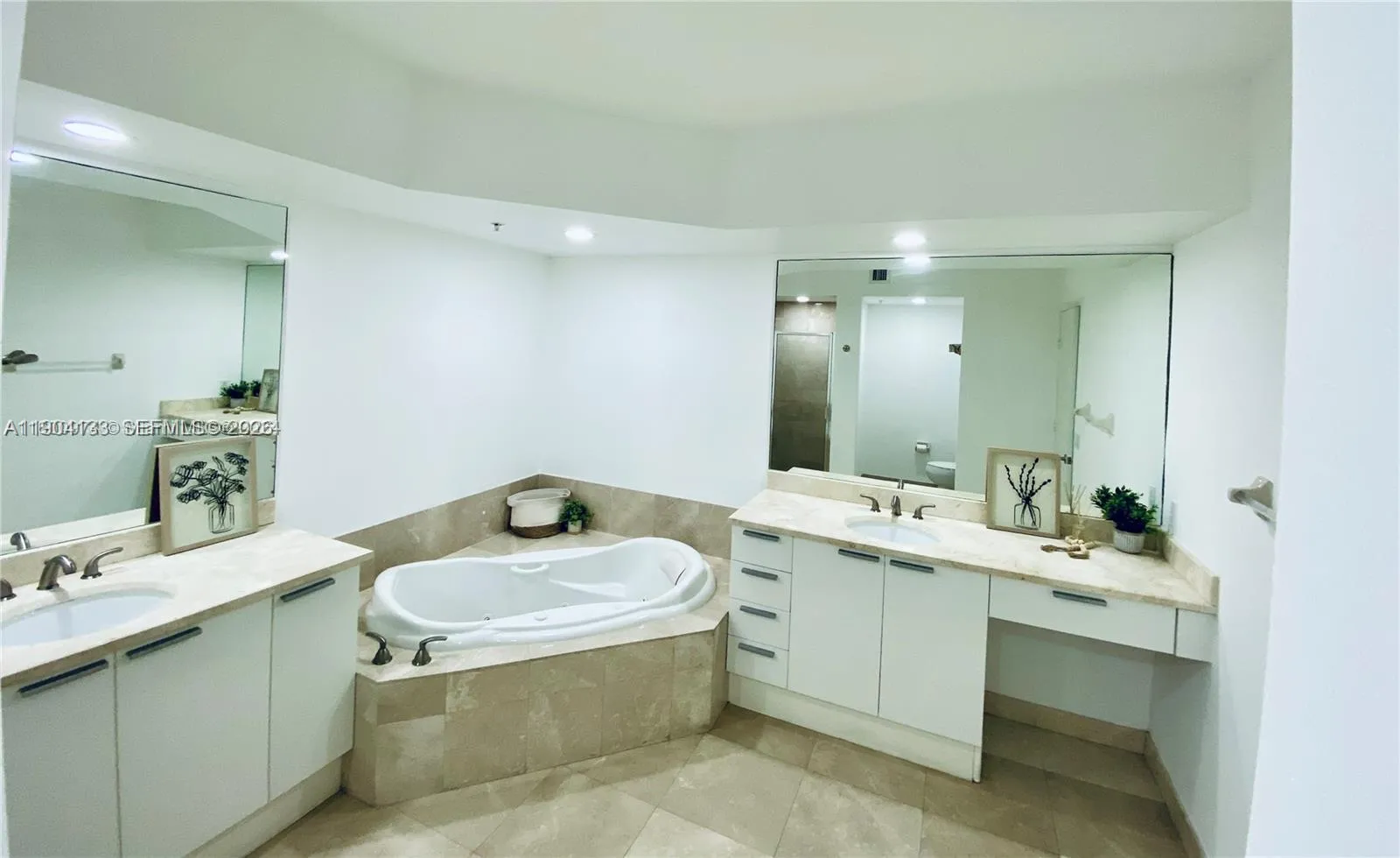 Master bathroom features dual sinks, jacuzzi tub and shower