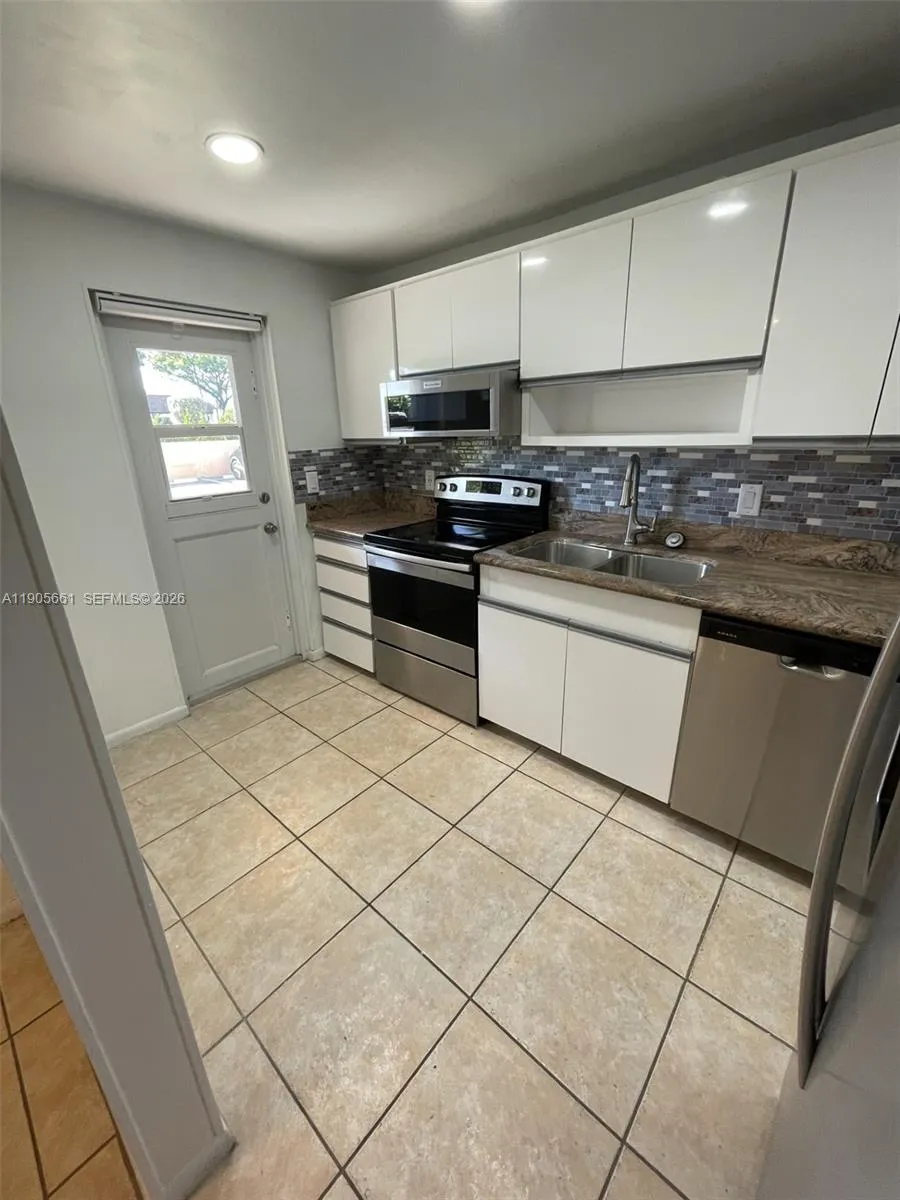 Kitchen with New Stainless Steel Appliances and Recessed Ceiling Lights