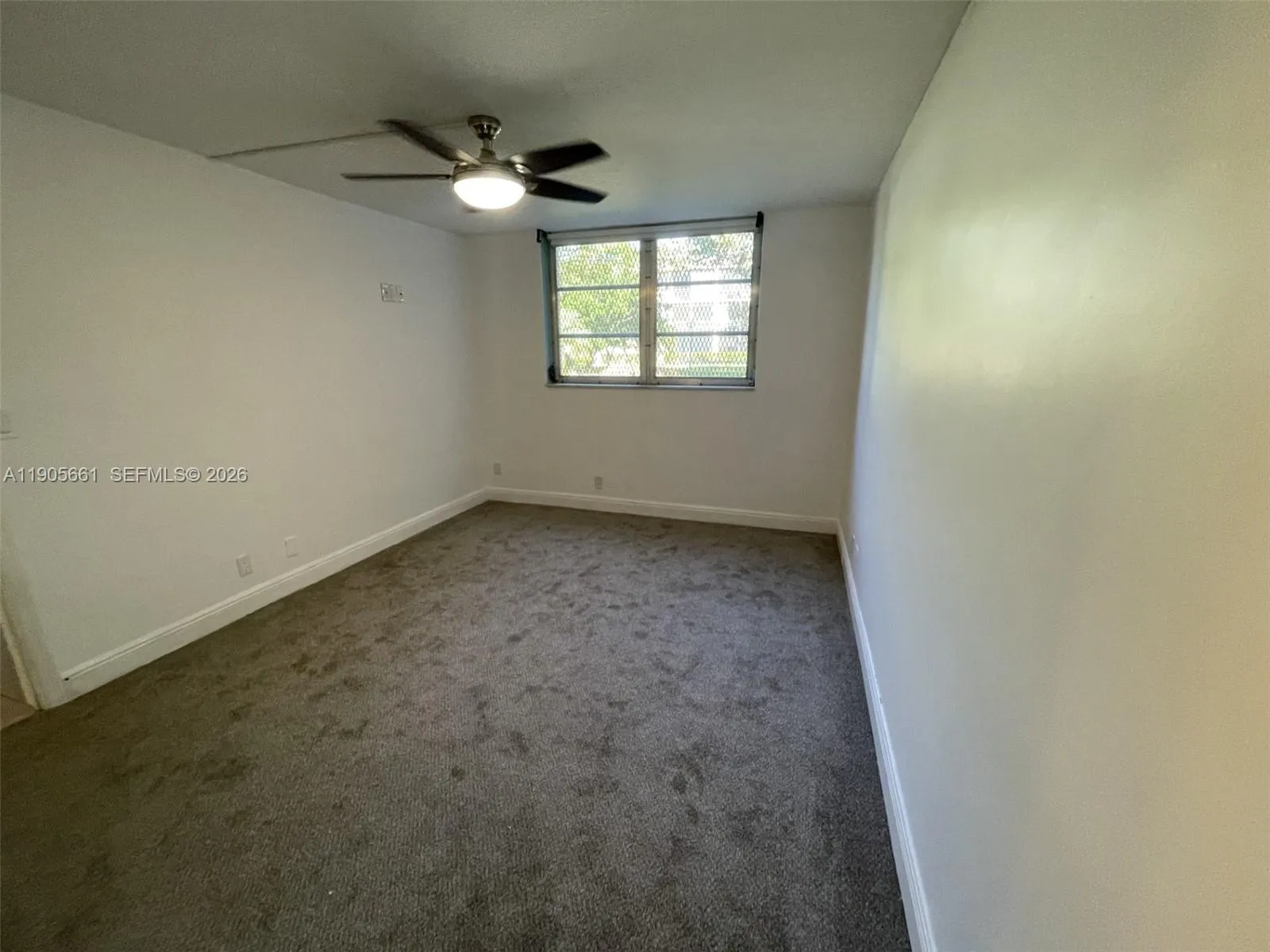 Master Bedroom with Garden\'s View and Ceiling Fan with Dimmable Lighting.