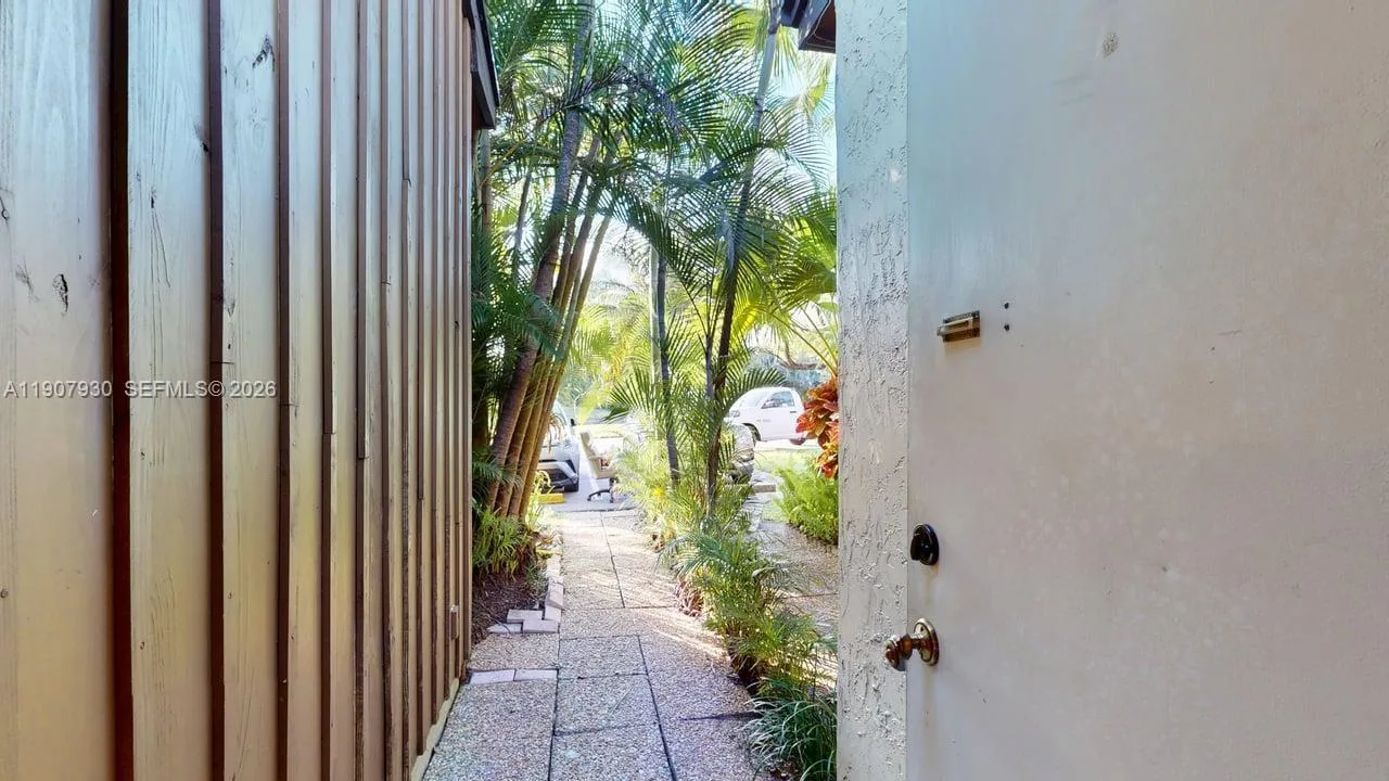 Welcoming entryway framed by greenery, setting the tone for a peaceful and private home experience.