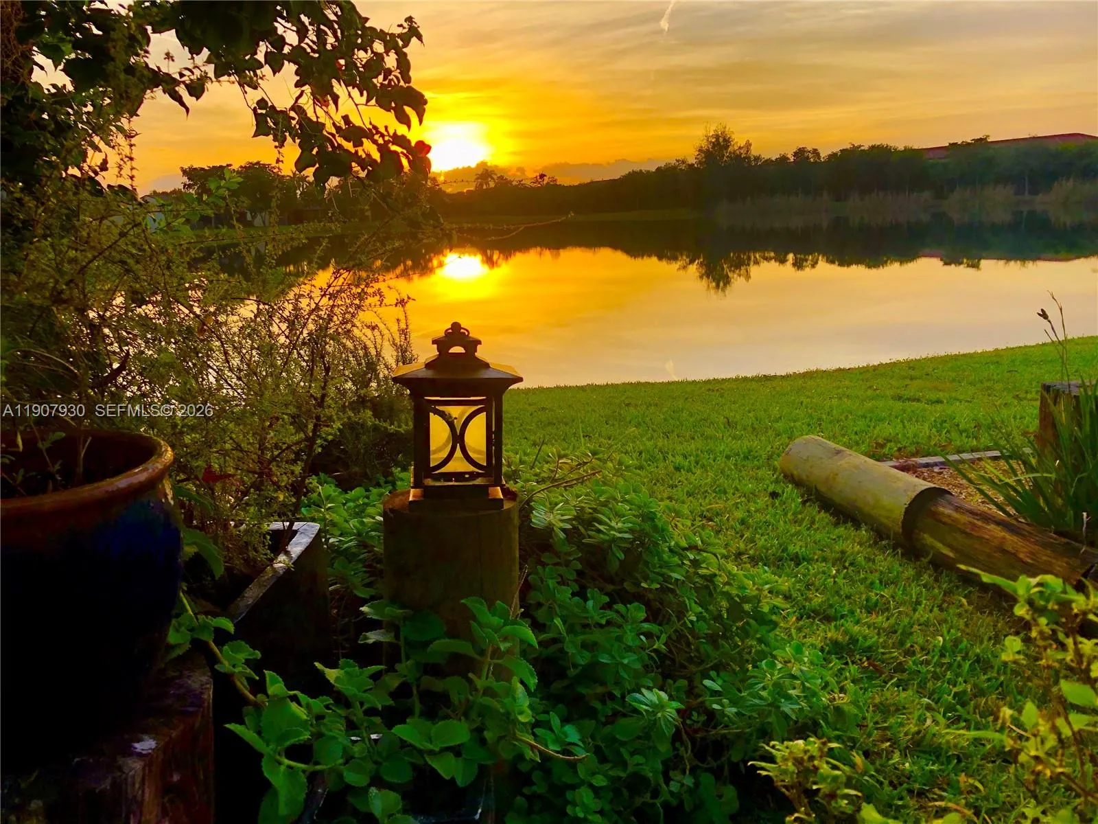 Serene backyard retreat framed by lush greenery and calm waters perfect for morning coffee or weekend relaxation