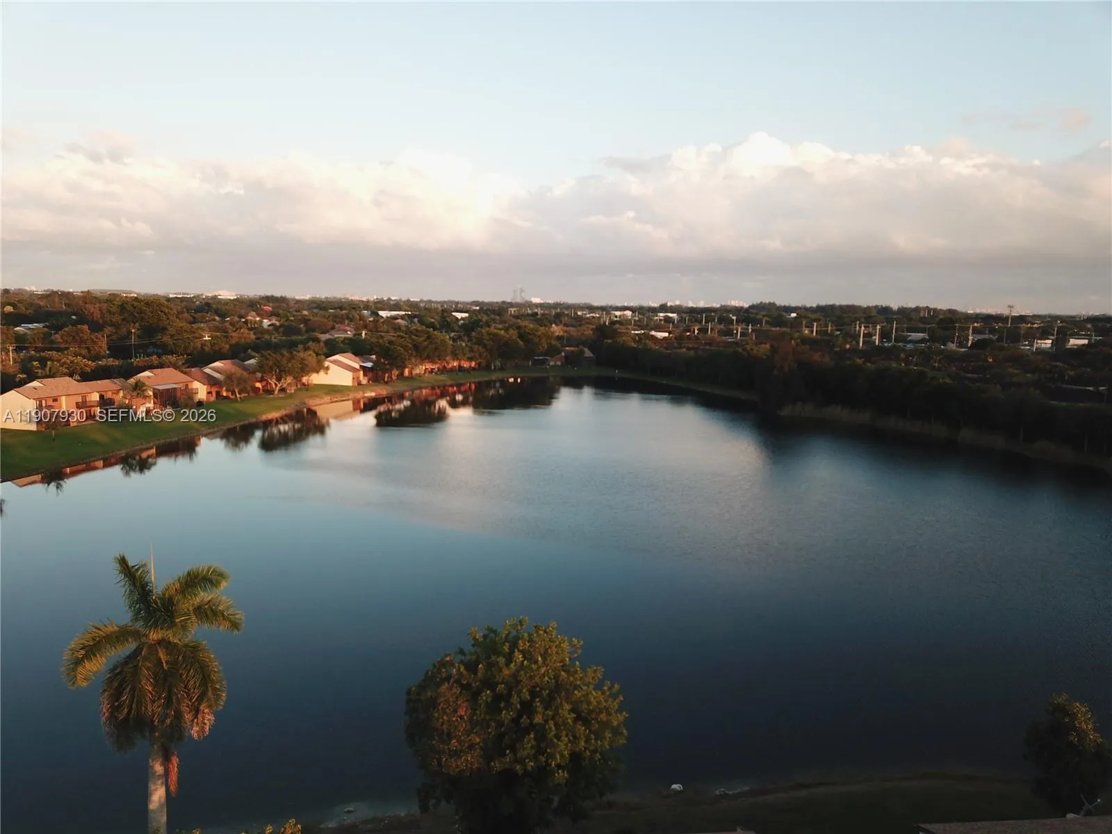 Breathtaking aerial view of Indian lake showcasing the serene water, lush greenery and peaceful neighborhood surroundings.