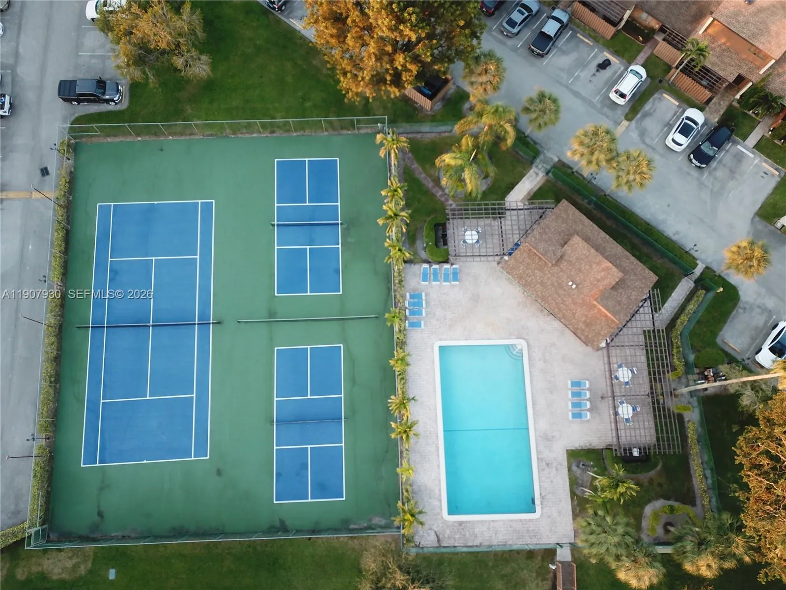 Community amenities featuring tennis courts, a large pool, and spacious sun deck
