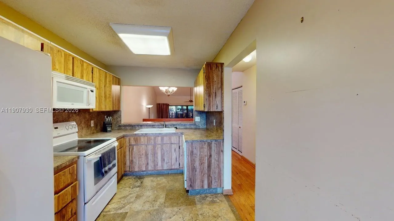 Cozy kitchen perspective capturing warmth and connection to the backyard greenery.