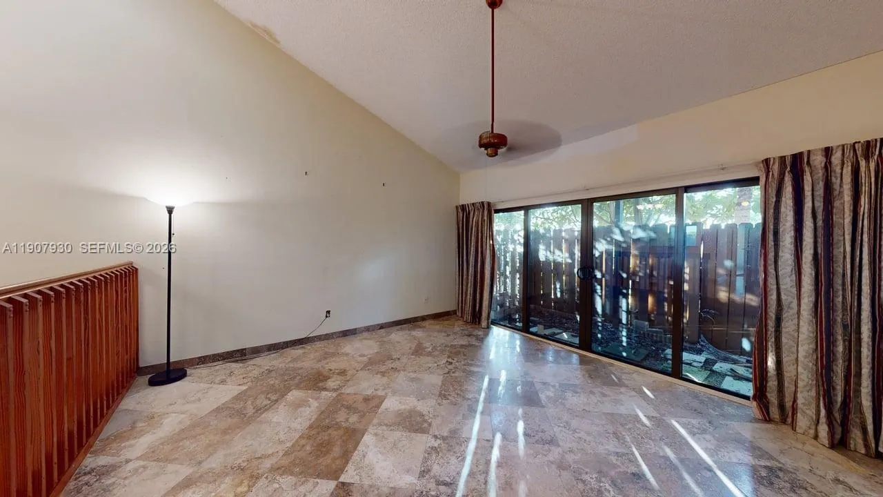 Wide perspective showcasing the open floor plan and connection to the scenic backyard oasis.