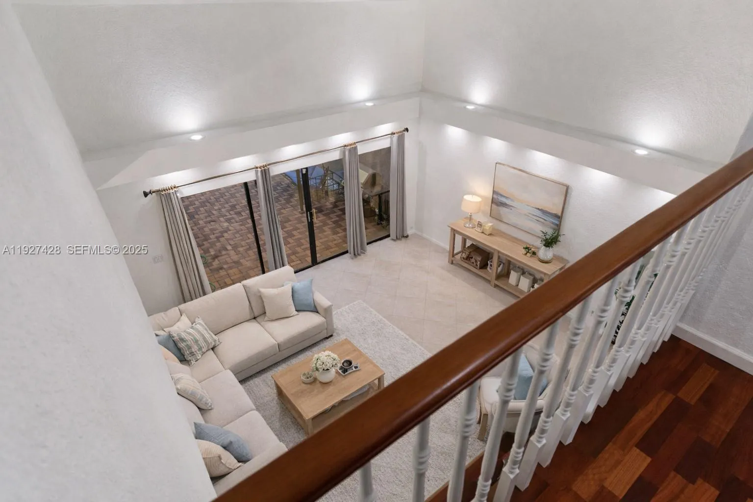 Upstairs view of living room with high ceilings