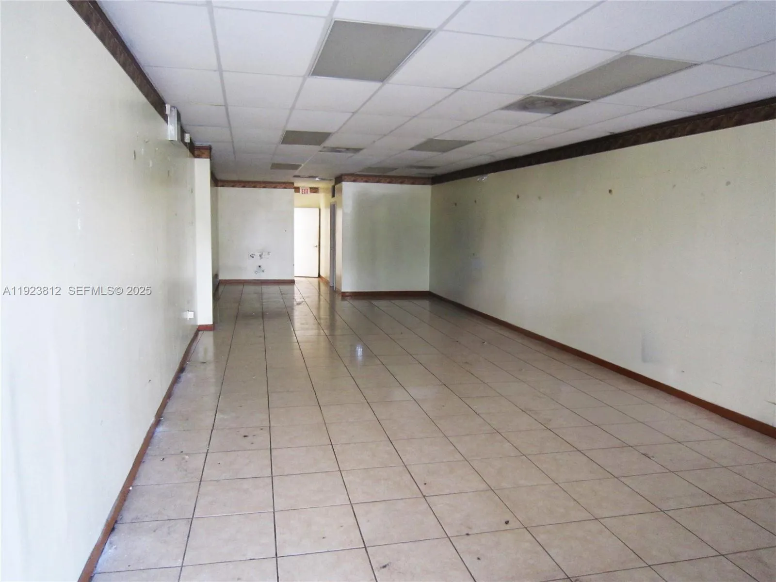 Old interior photo while being cleaned up.  Current build out has a wall separating the middle of the space.