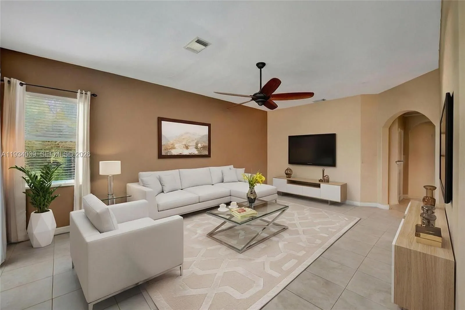Digitally staged Family Room open to kitchen area