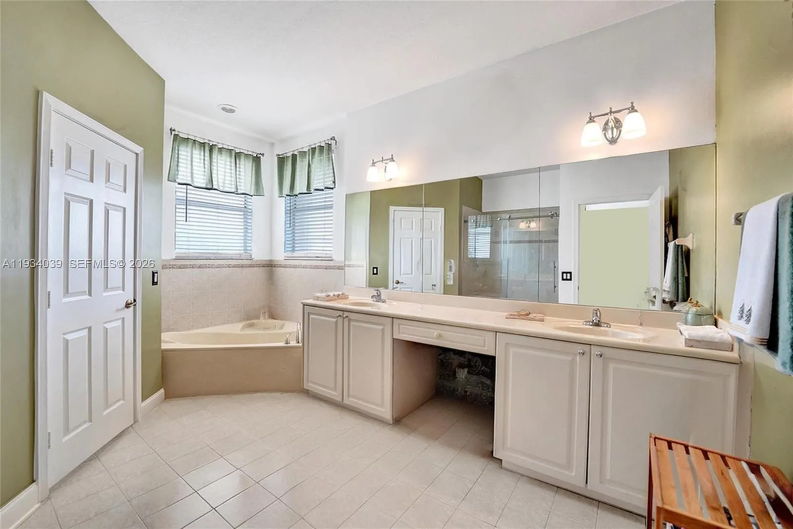 Master bathroom with dual vanity sinks and soaking tub