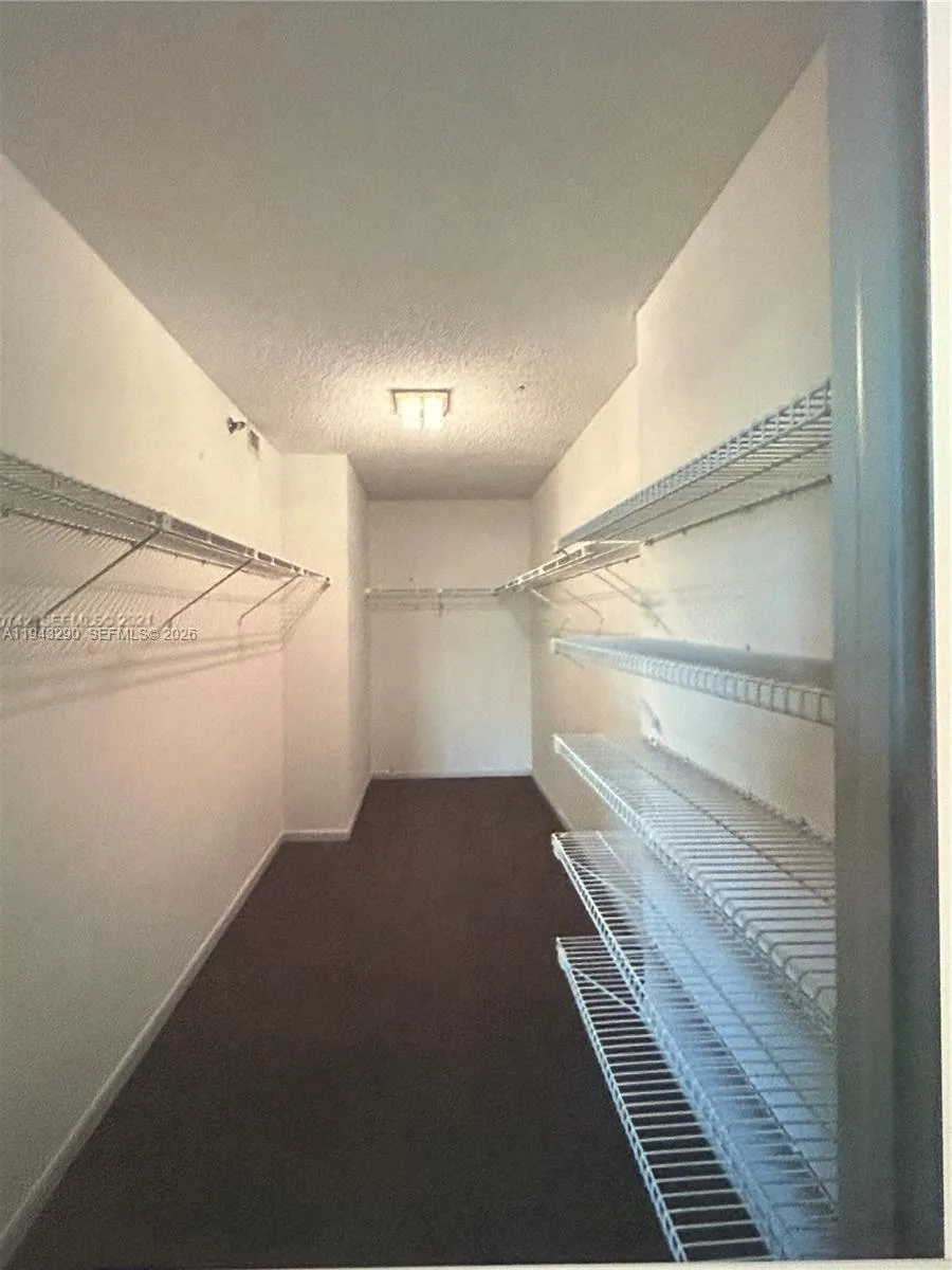 very large walk in closet in primary bedroom