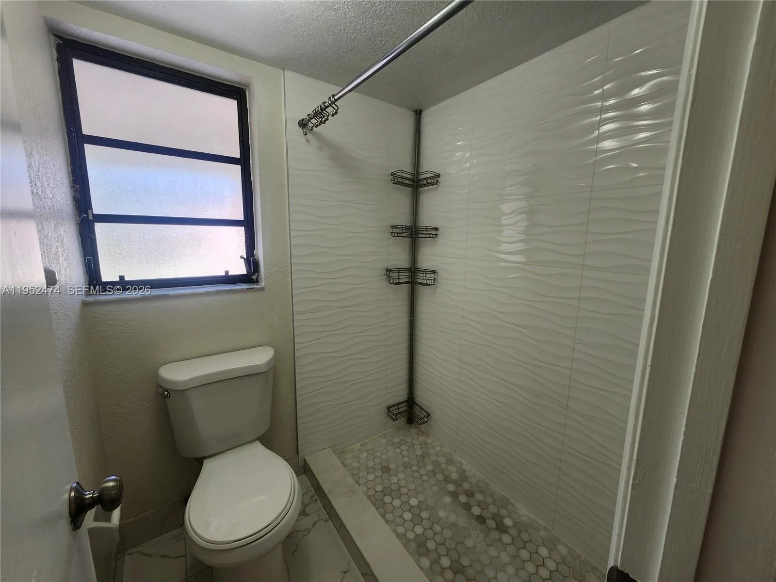 Primary Bathroom with Shower and Walk-in Closet on the Opposite Side.