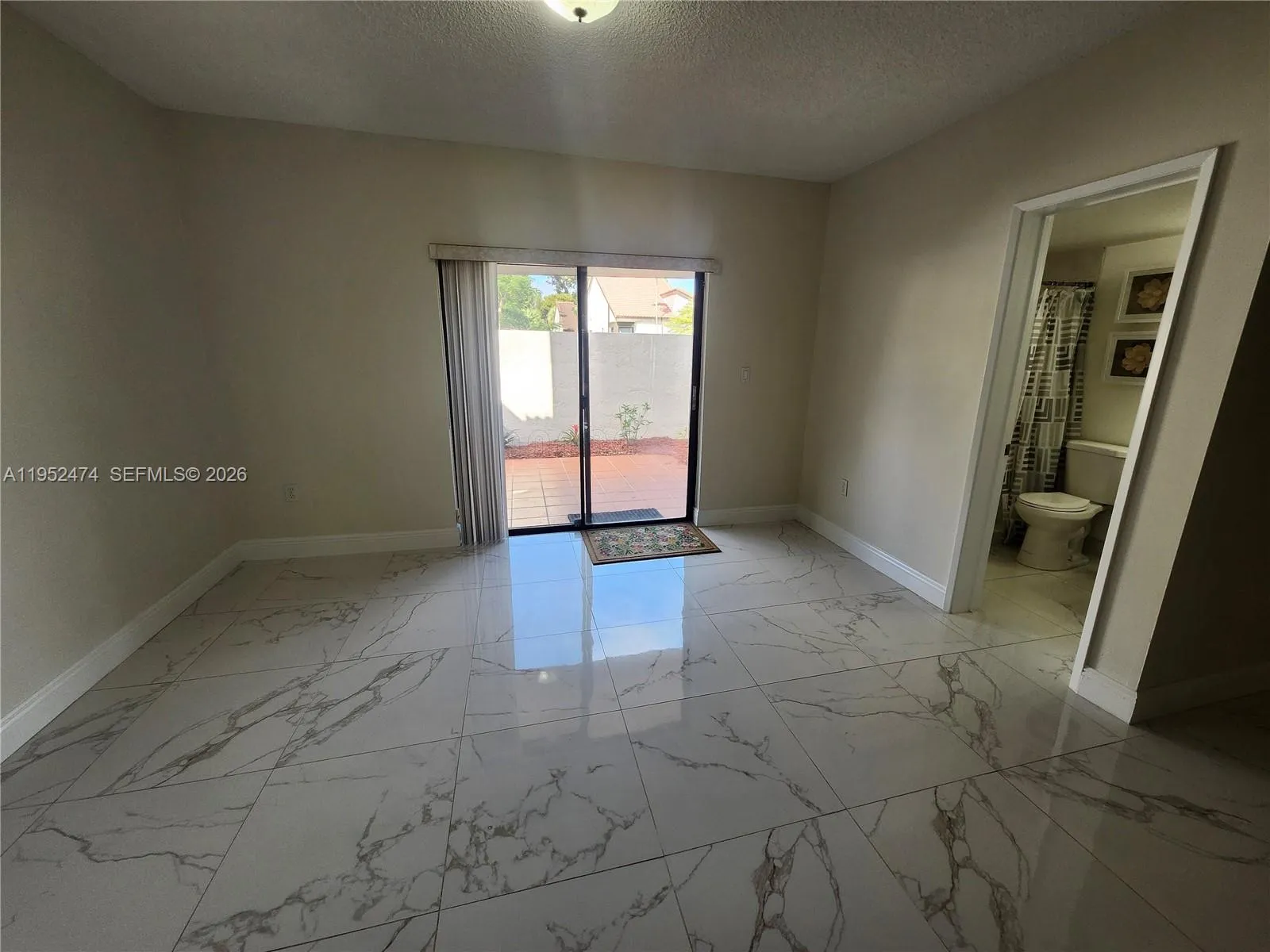 Flex Space with Sliding Glass Doors that Lead to the Front Patio.