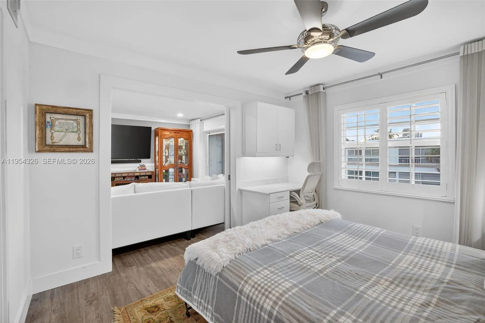 3rd bedroom w/ murphy bed wall system and built in desk w/ quartz counter and window shutters