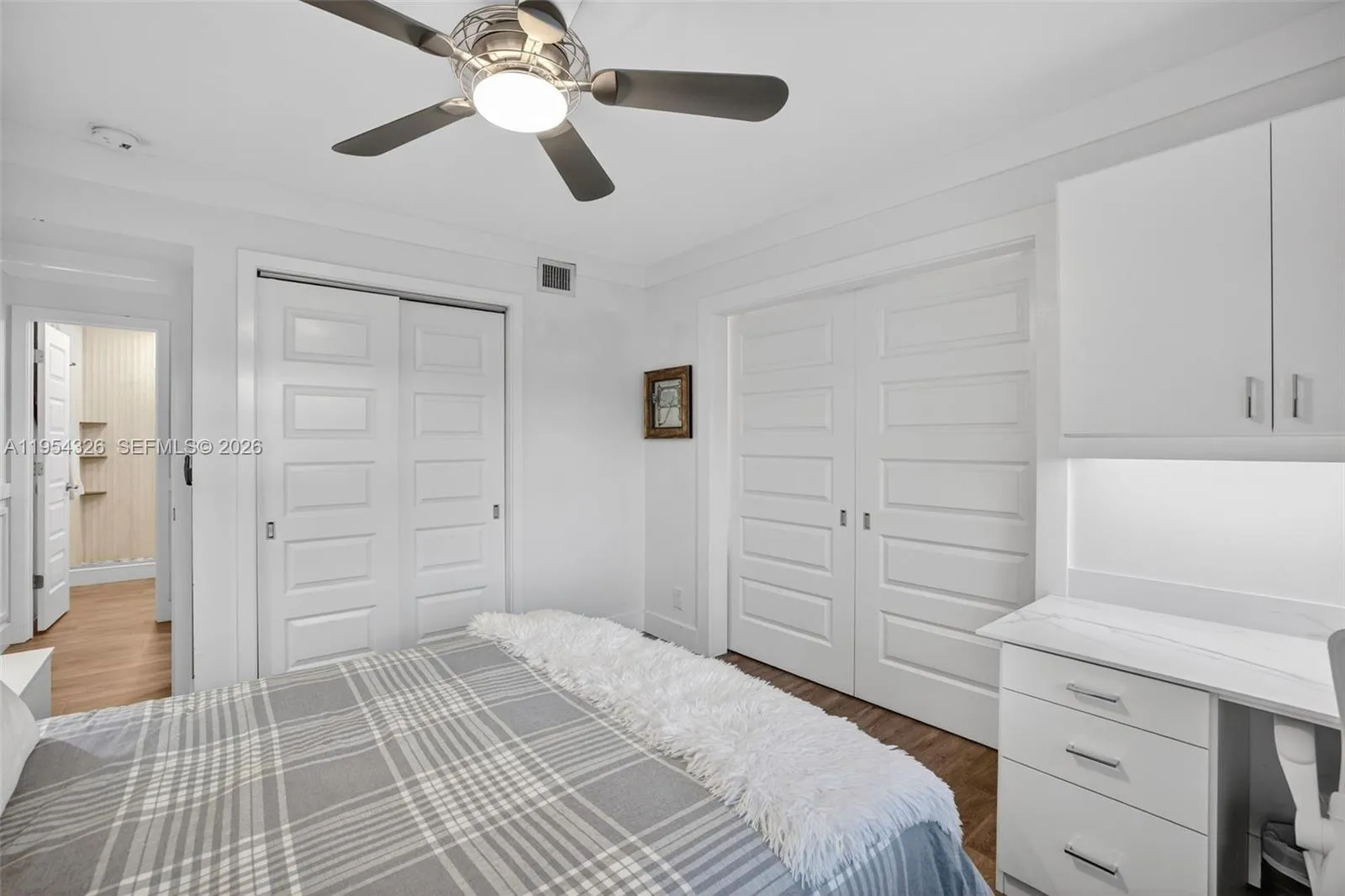 3rd bedroom w/ murphy bed wall system and built in desk w/ quartz counter and window shutters