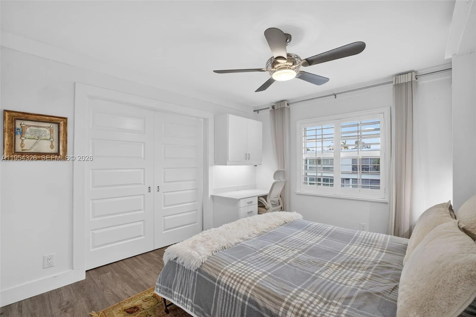 3rd bedroom w/ murphy bed wall system and built in desk w/ quartz counter and window shutters