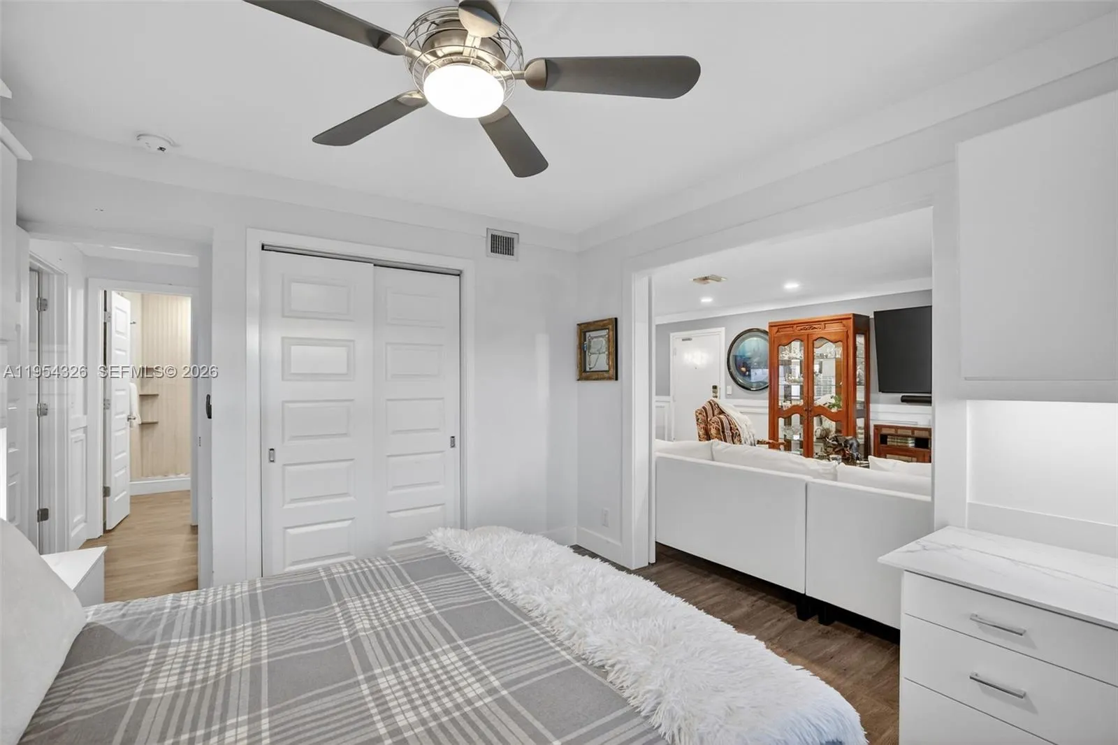 3rd bedroom w/ murphy bed wall system and built in desk w/ quartz counter and window shutters (with doors open to family room) in event this becomes your office