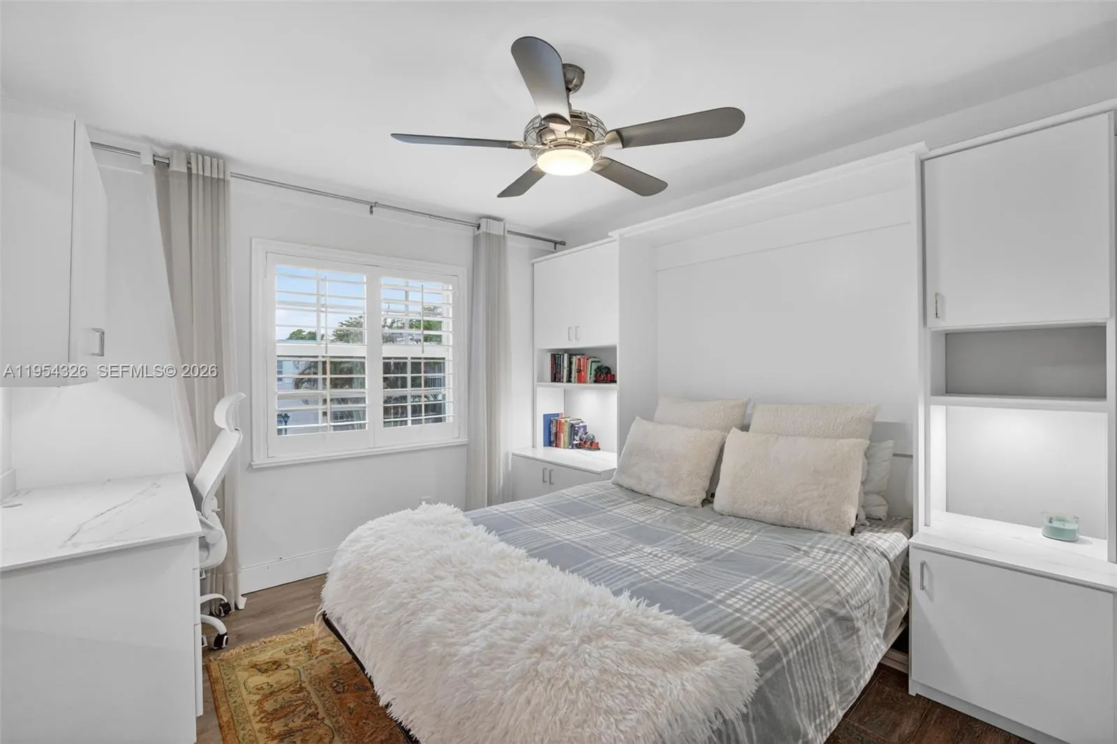 3rd bedroom w/ murphy bed wall system and built in desk w/ quartz counter and window shutters
