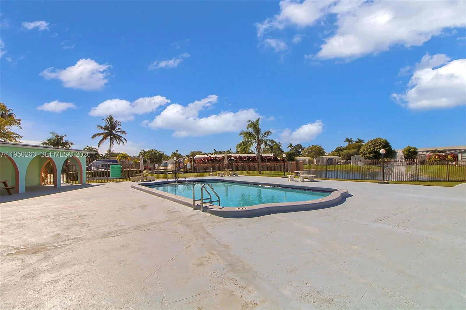 Clubhouse, lake, pool and playground view