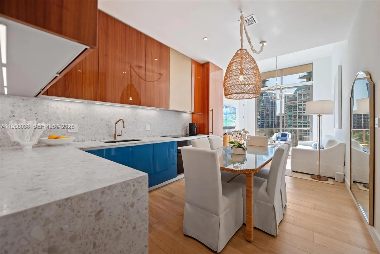 Spacious open kitchen and entryway showcasing premium finishes, recessed lighting, and contemporary European design in Coconut Grove.