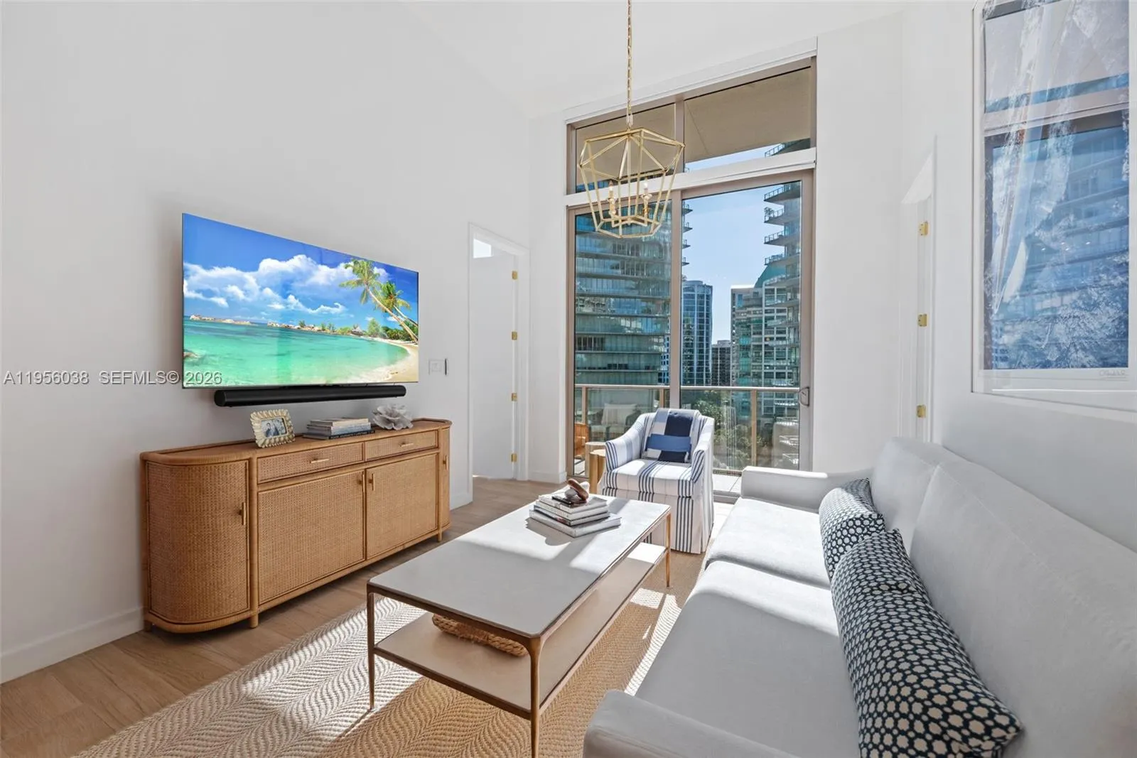 Versatile second bedroom ideal for guests, home office, or den, featuring oversized windows and contemporary finishes at Mr. C Coconut Grove.