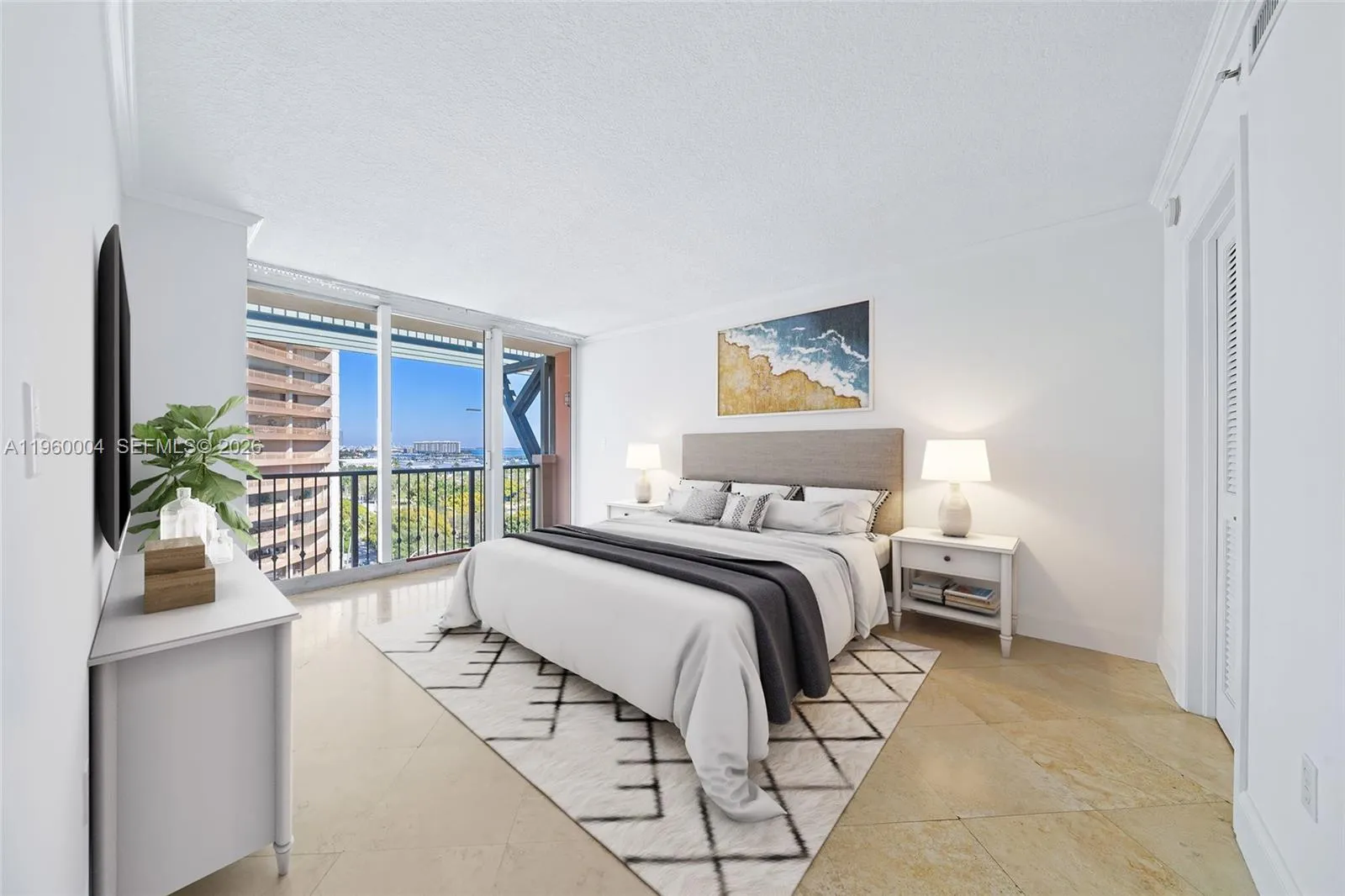 *Virtually Staged* Primary bedroom features a walk-in closet, en-suite bathroom, and bay views