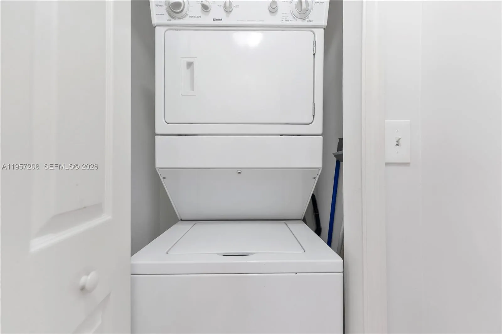 Convenient in-unit laundry featuring a space-saving stacked washer and dryer.