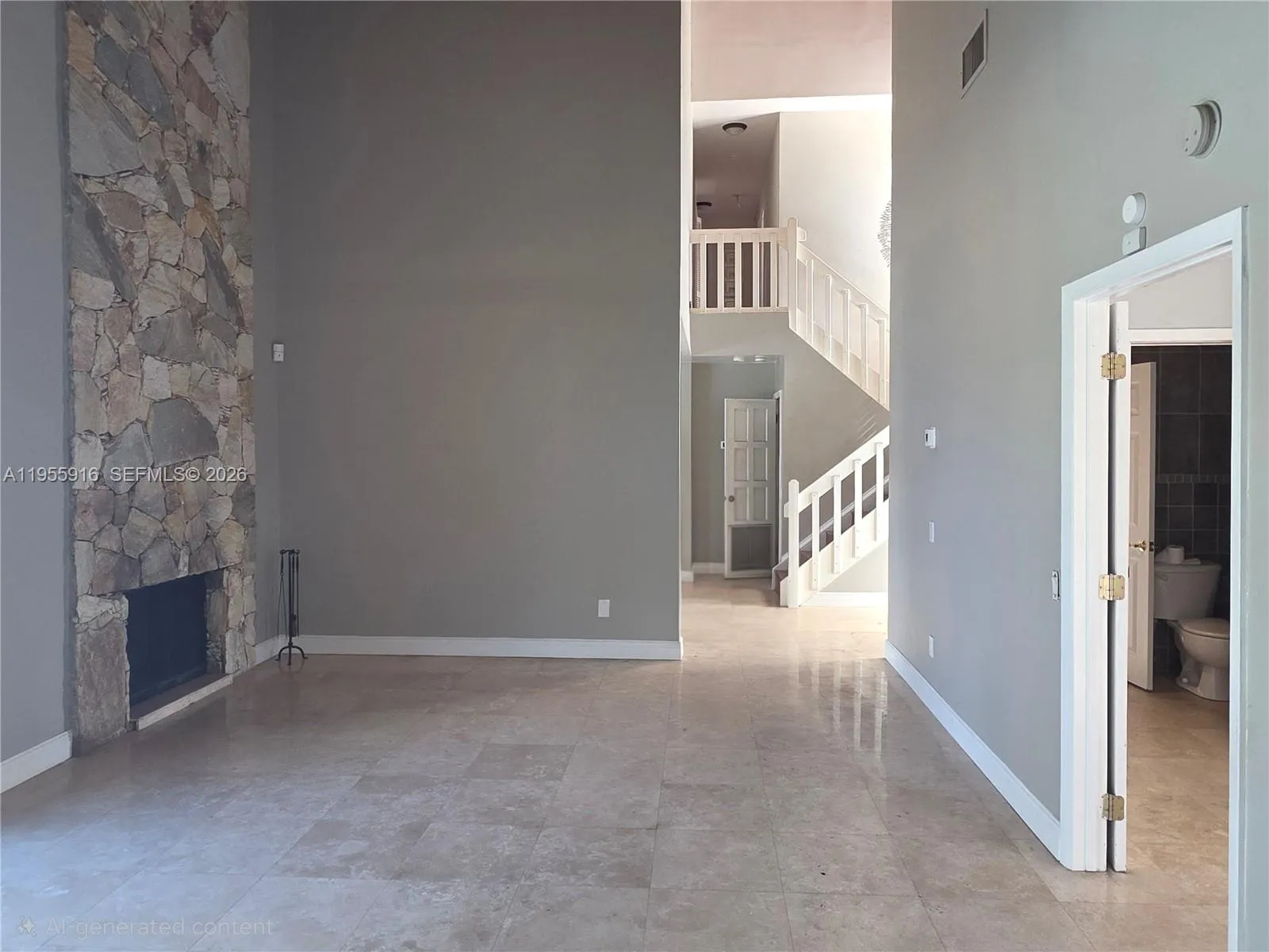 Elegant & ample formal living room with high ceilings and chimney.