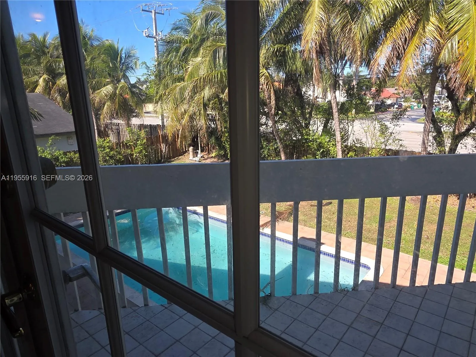 Primary bathroom\'s balcony overlooking the pool and backyard.\n