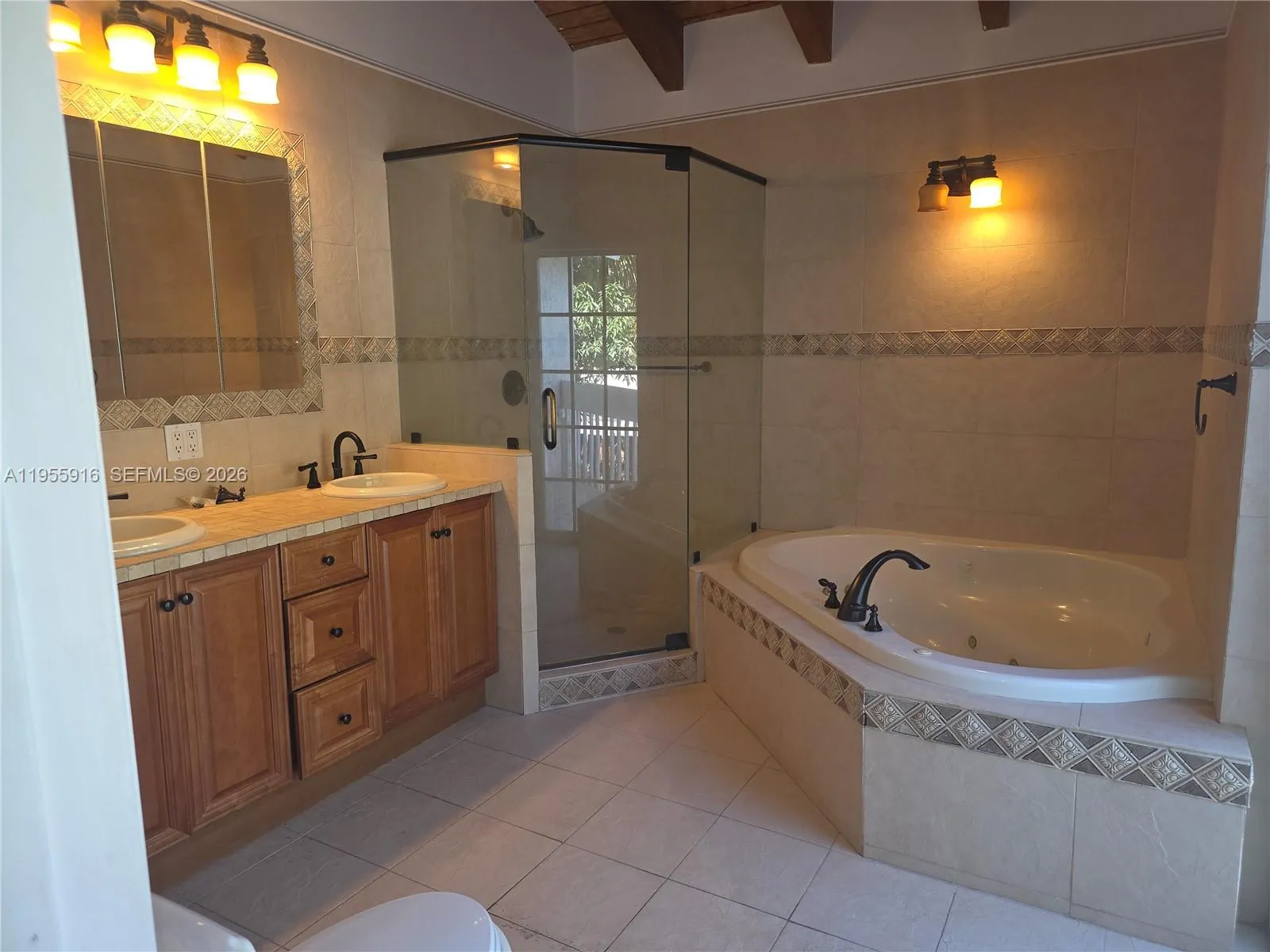 En-suite bathroom with balcony overlooking the pool.