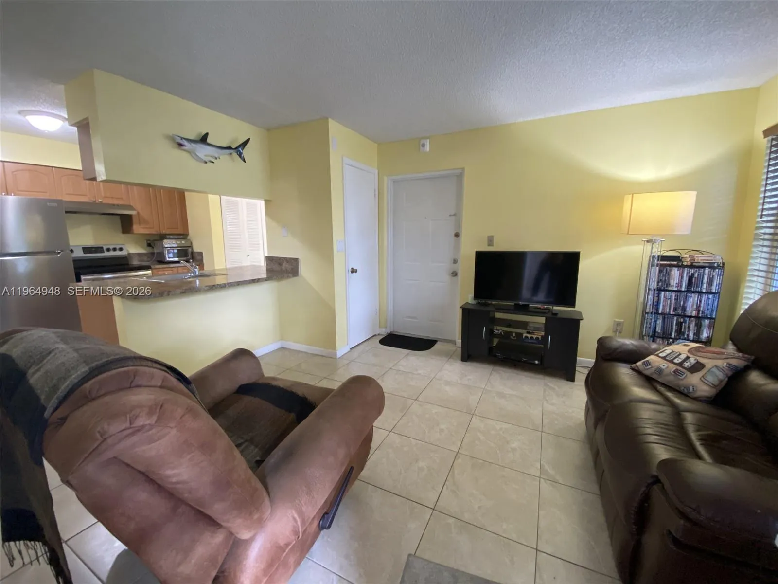 Living room with natural light from 2 large windows, good size closet as you first walk in and kitchen counter where you can place stools