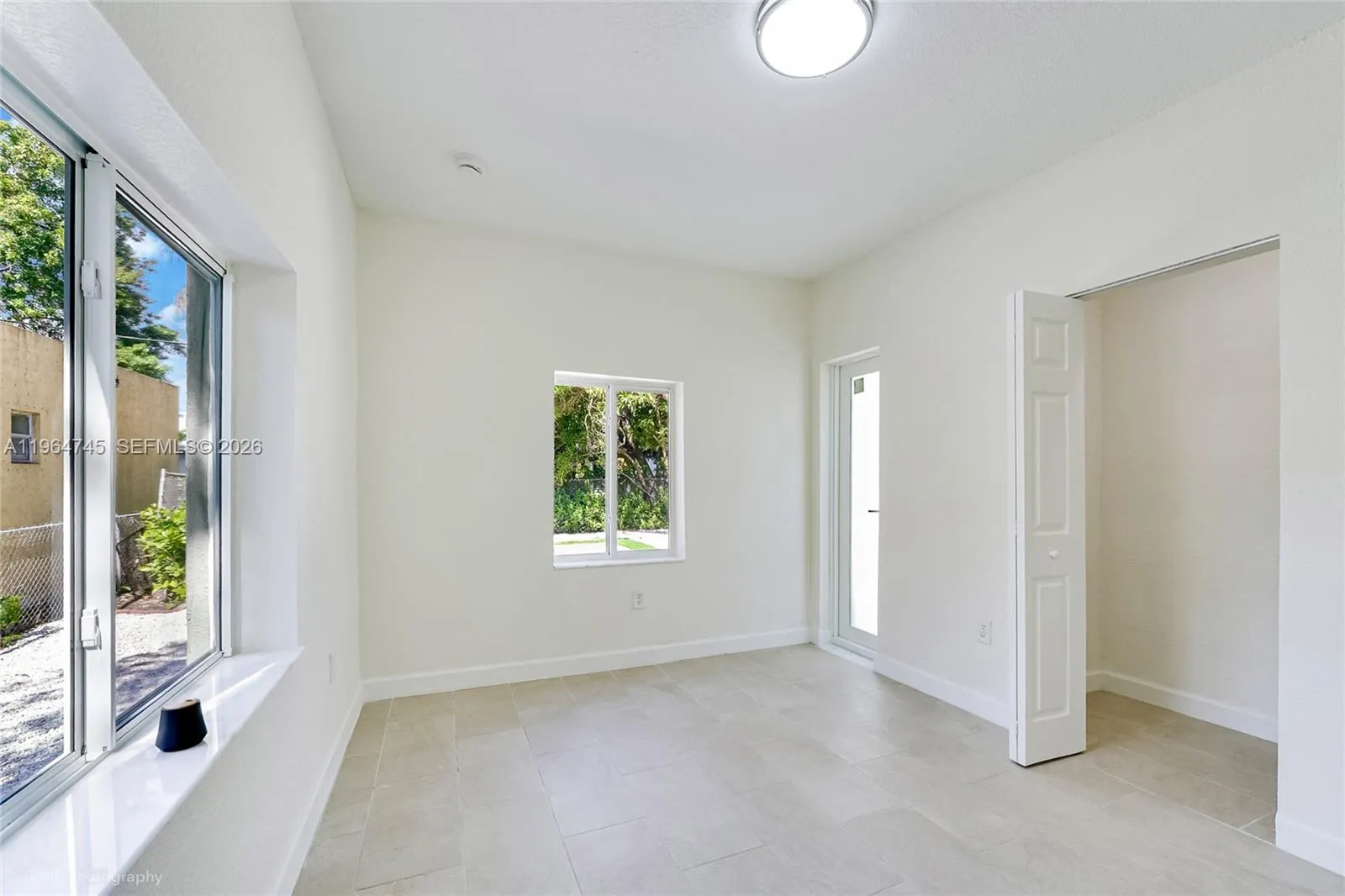 Bedroom 2 with exit door to backyard