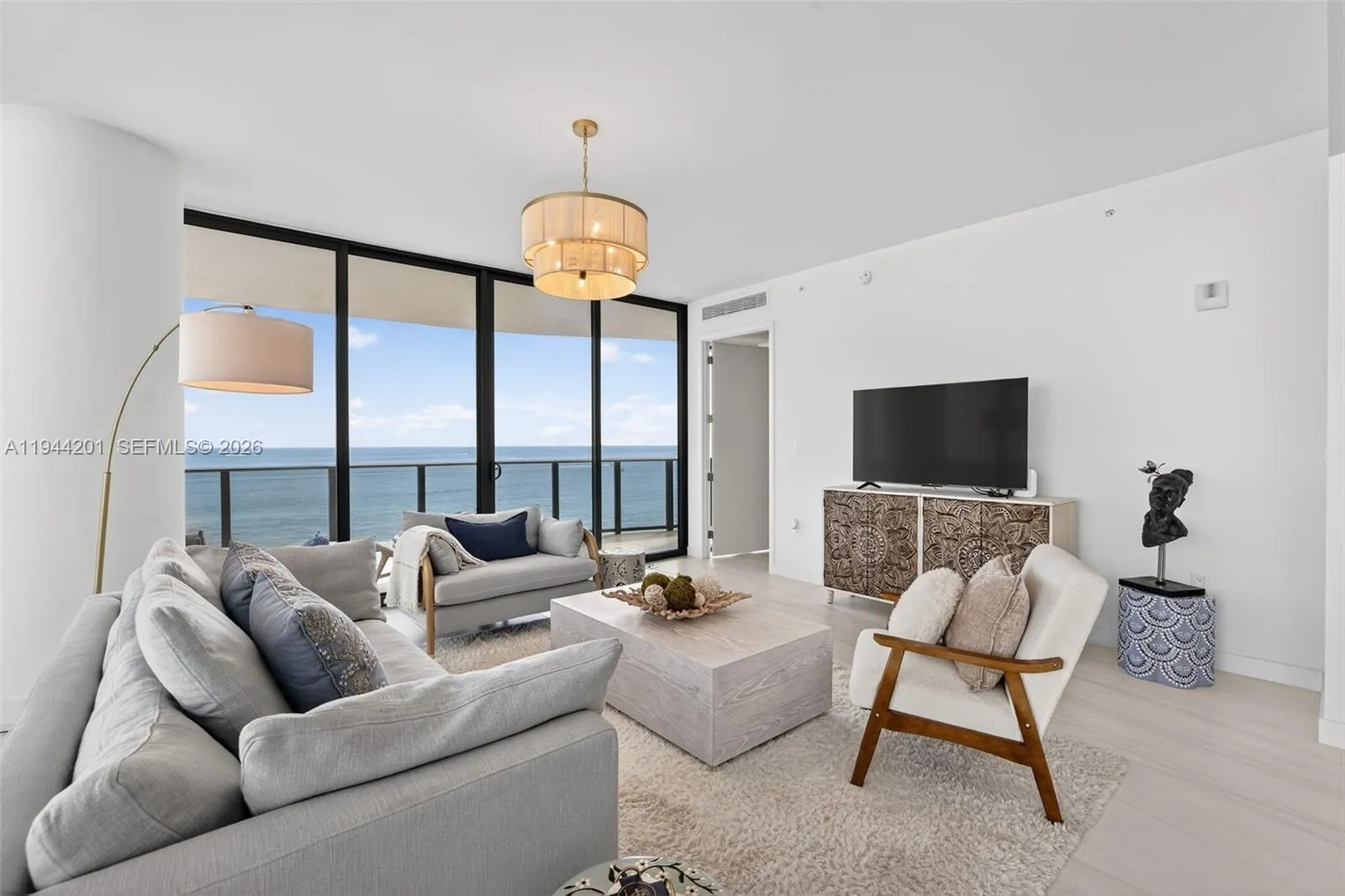 Light filled open living area with floor to ceiling glass and seamless indoor outdoor flow to expansive terrace.