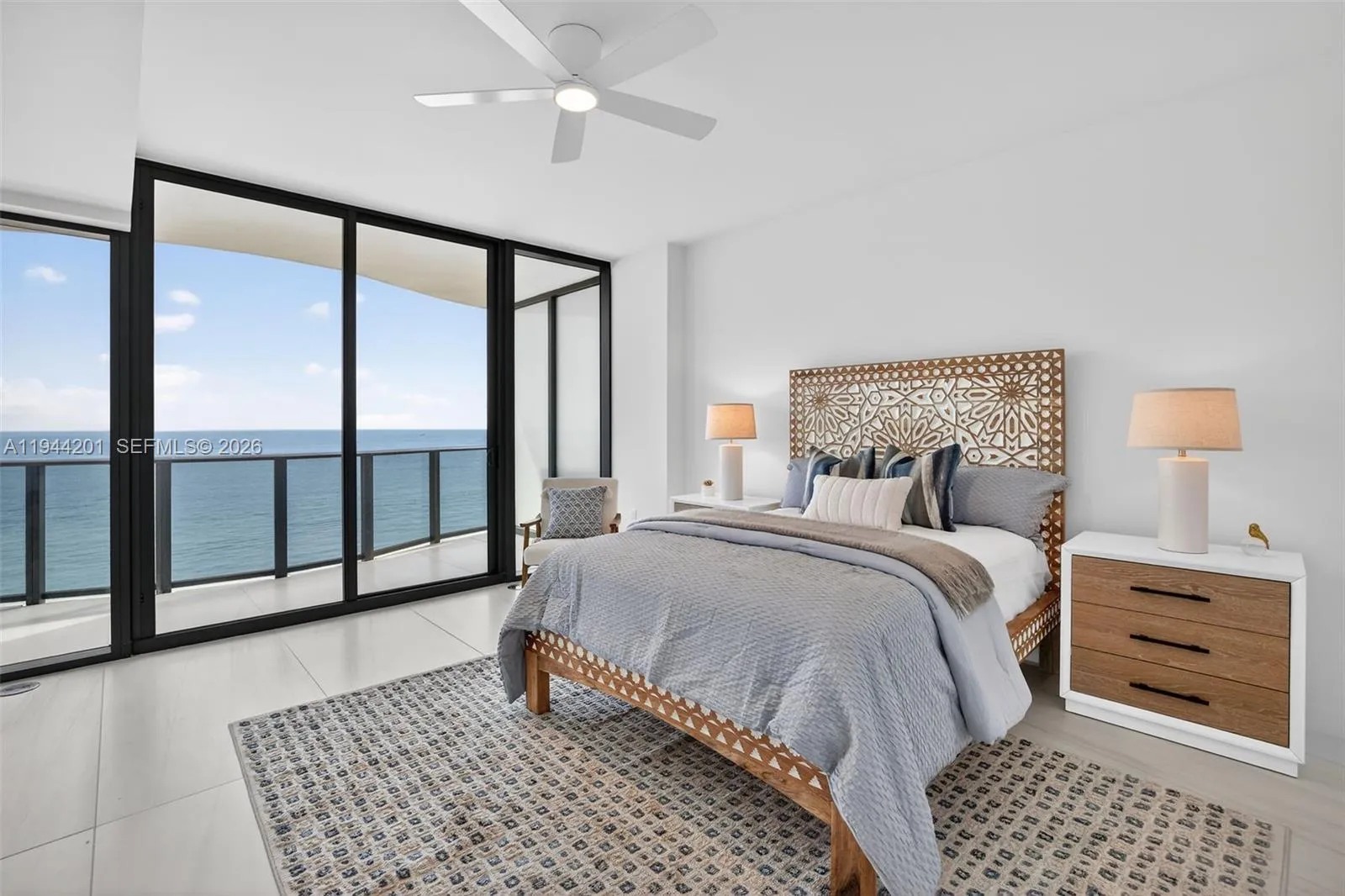 Spacious primary suite with floor to ceiling glass, terrace access, two walk in closets, and spa inspired bath.
