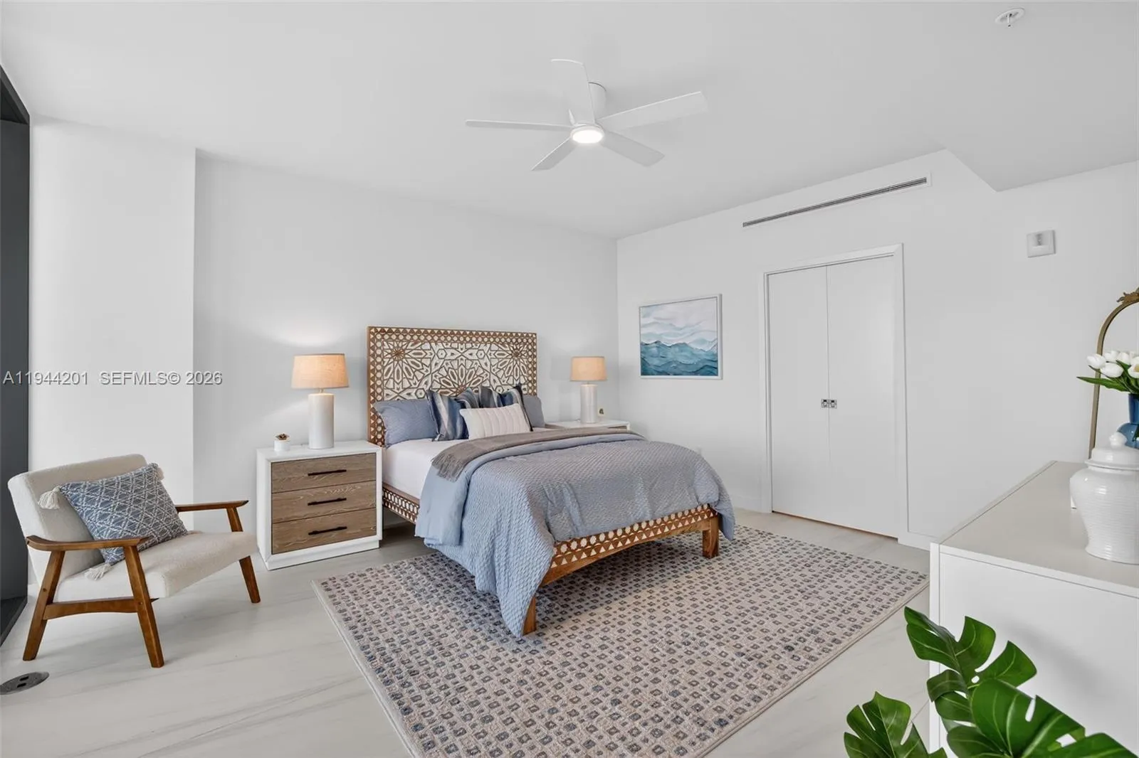 Spacious primary suite with floor to ceiling glass, terrace access, two walk in closets, and spa inspired bath.