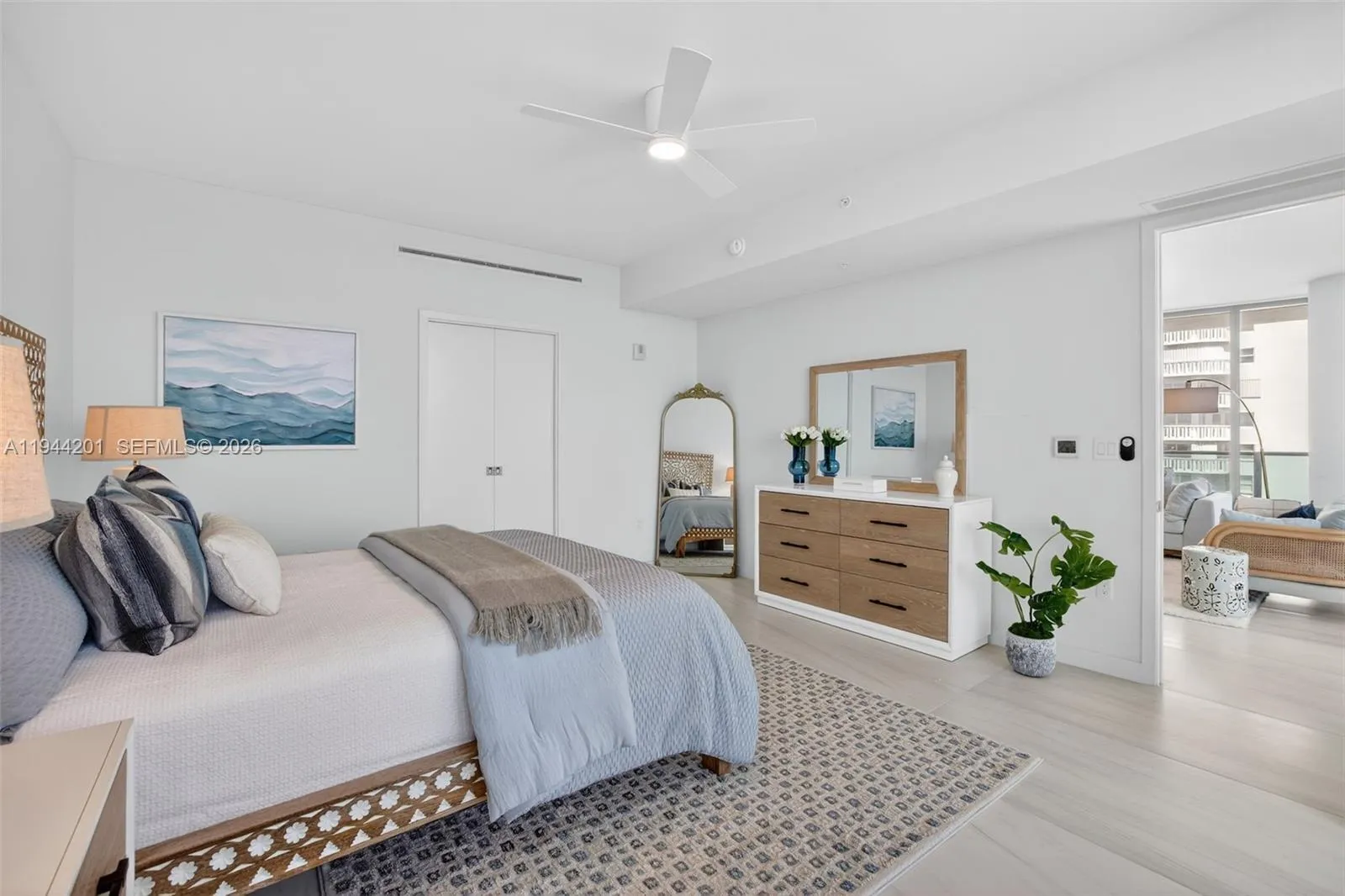 Spacious primary suite with floor to ceiling glass, terrace access, two walk in closets, and spa inspired bath.