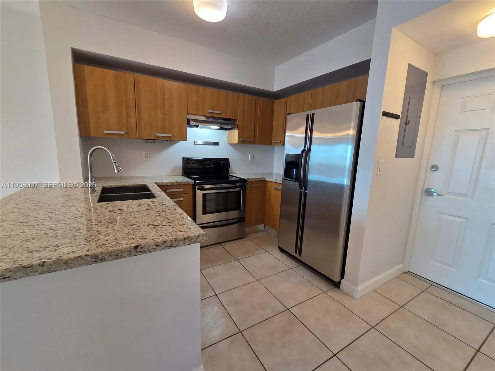 Open-concept kitchen positioned near the entry foyer for practical everyday living.