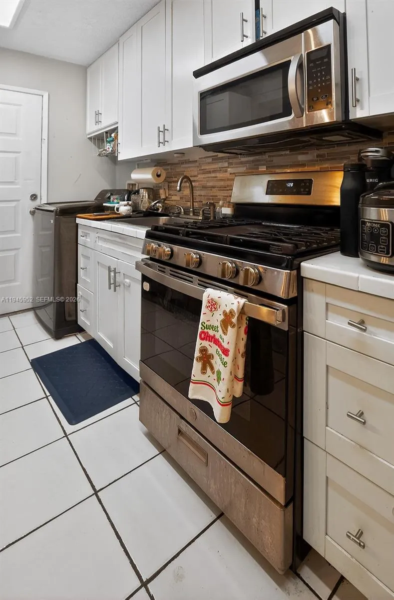 Kitchen equipped with stainless steel appliances, offering a clean and modern finish.