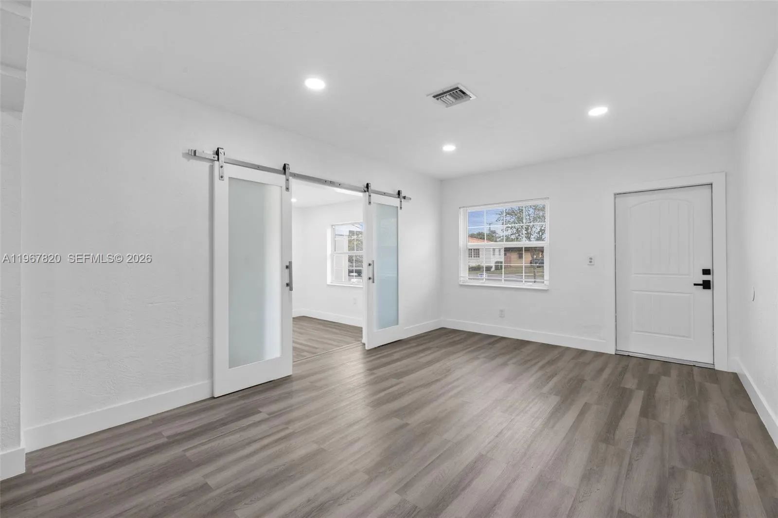 Living Room with front door and den entry view