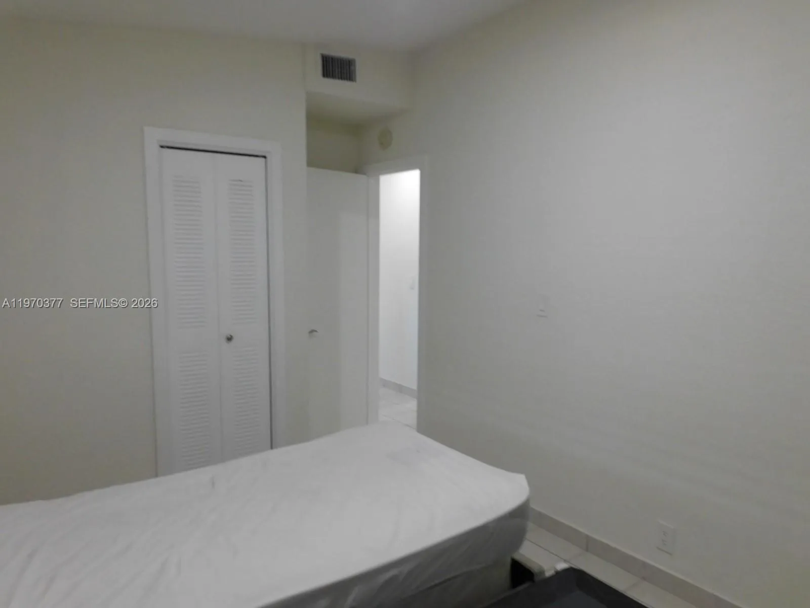 2nd bedroom view to entry door.